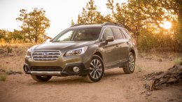 2015 Subaru Outback in light green in the desert at sunrise